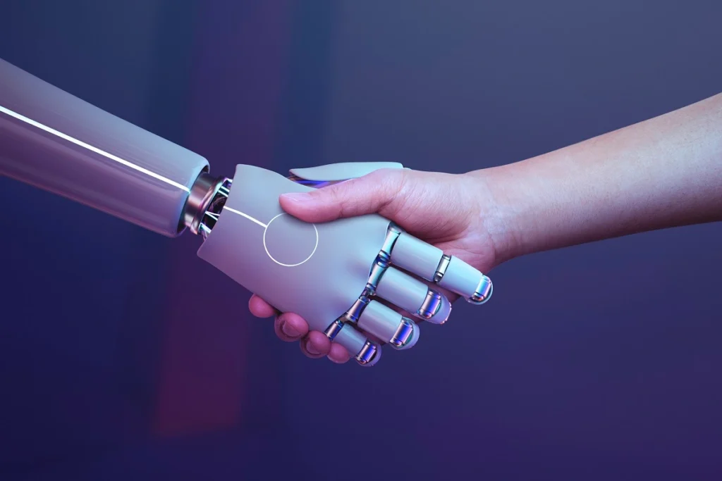 67117dc2d4a787e88cd38cdd_robot-handshake-human-background-futuristic-digital-age